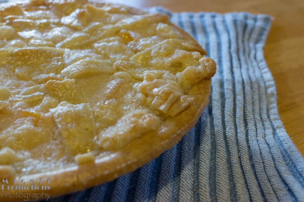 A photo of peach pie on a towel cooling. © Miceli Productions Photography