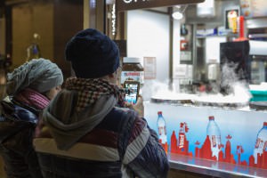 People waiting for crepes using their phones, Paris, France