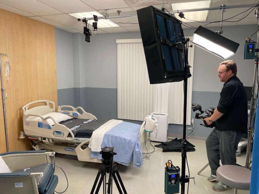 Miceli Productions built this hospital room as a set for a video production. This image shows behind the scenes with video equipment set up for filming