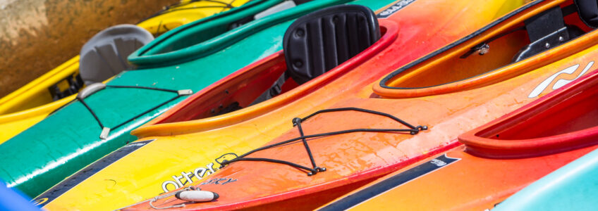 Kayaks floating in the water on the lake. Photo by Miceli Productions, Hartford, CT. {{brizy_dc_image_alt entityId=