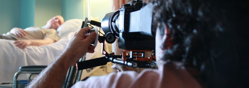 Using Video for Business marketing is essential, Miceli Productions offers video production services like seen in the photo. Photo of Michael Miceli filming a scene in a hospital. {{brizy_dc_image_alt entityId=