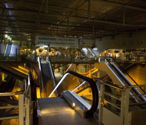 Escalators converge in a Paris Train Station showing a very bare, but industrial and machinery based image of travel.